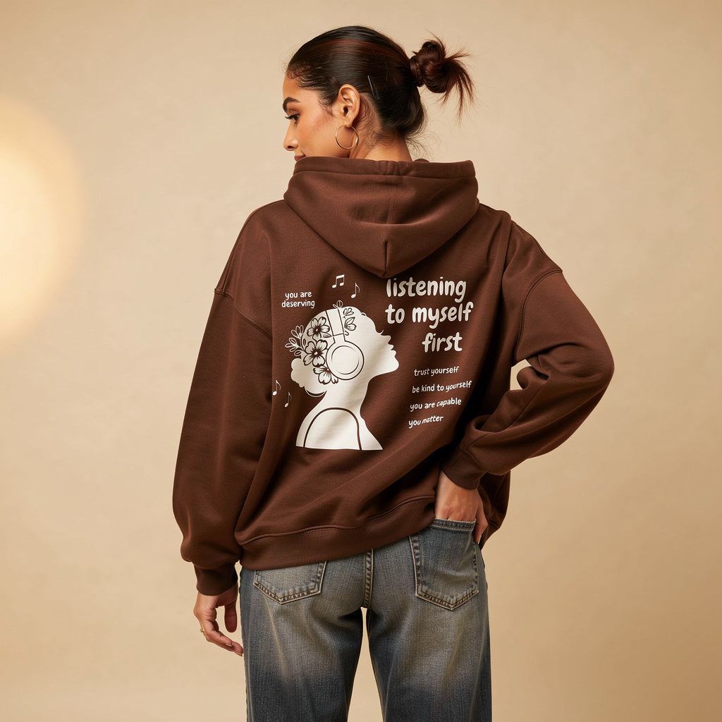 Model wearing listening to myself first hoodie in Coffee with white graphic.