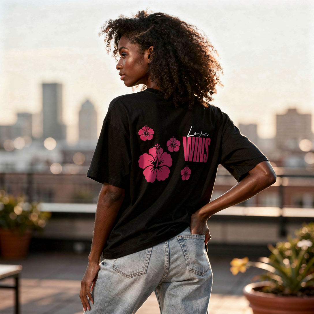 Model wearing Love Wins Tee, White Lettering, Black