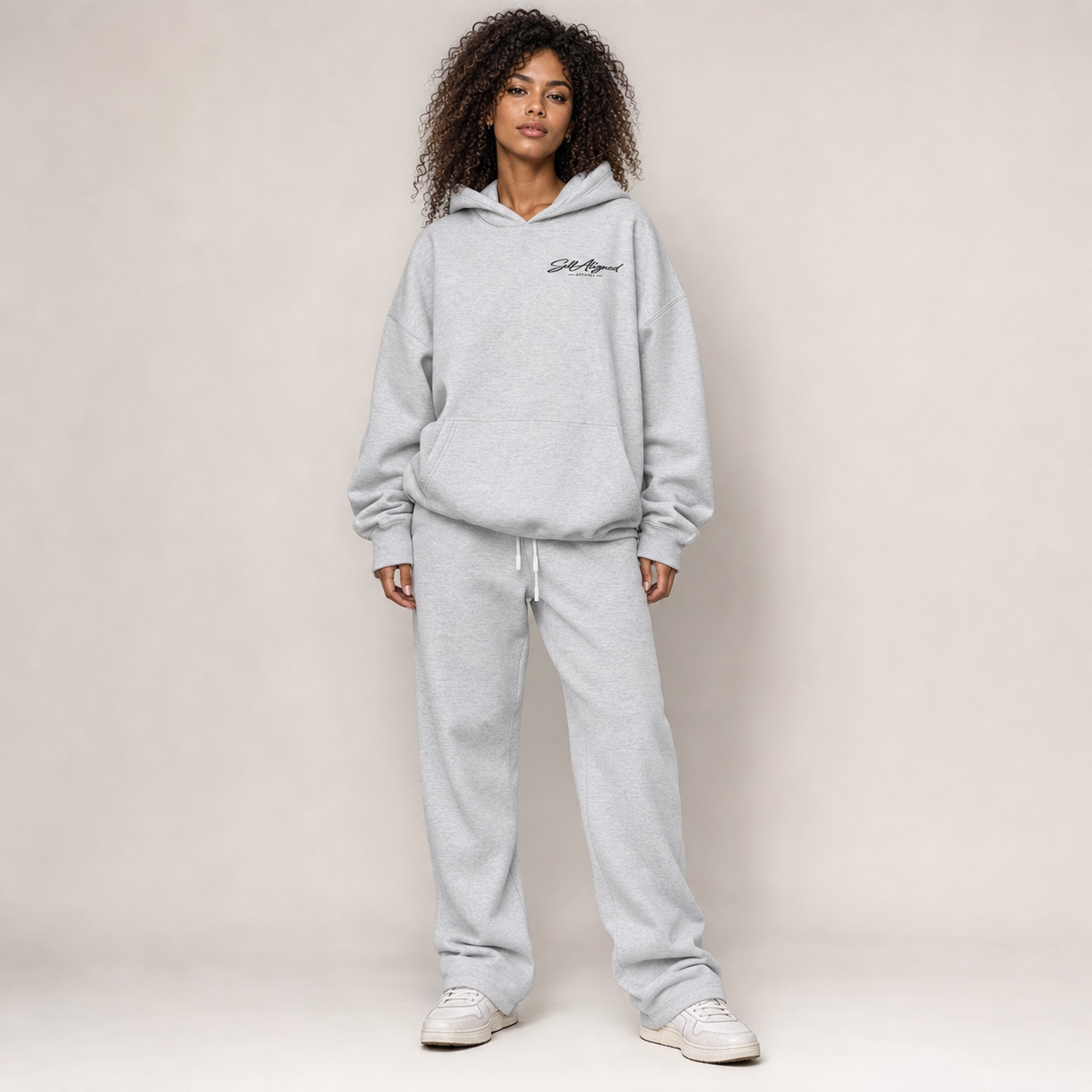 Women waring the Love Wins hoodie in floral grey with the floral grey sweatpants matching set. Front view.