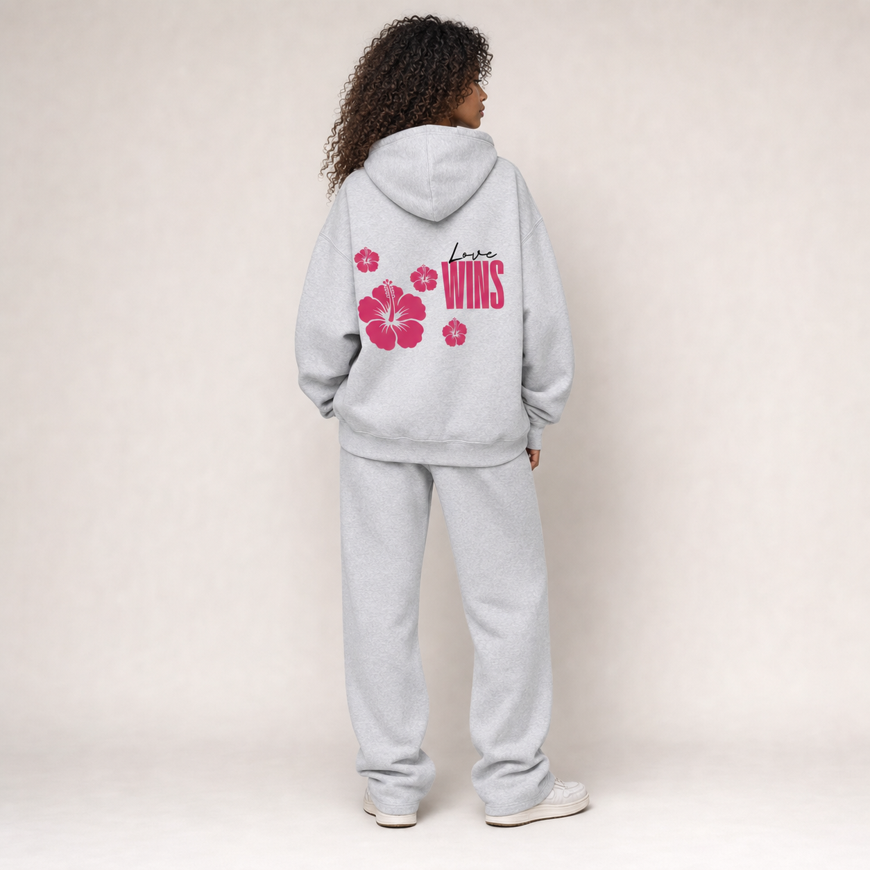 Women waring the Love Wins hoodie in floral grey with the floral grey sweatpants matching set. Back view.